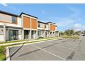 Modern townhome exteriors featuring a large parking area and inviting outdoor seating at 3308 Tranquil Trl, Kissimmee, FL 34747