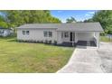 Charming single-story home with a modern white exterior, covered entry, and well-maintained lawn at 36 Morning Glory Dr, Debary, FL 32713