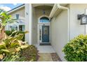 Inviting front entrance with a decorative glass door and tiled entryway at 462 Lakepark Trl, Oviedo, FL 32765