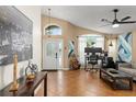 Open-concept living room with neutral paint, tile flooring, and arched windows for ample natural light at 462 Lakepark Trl, Oviedo, FL 32765