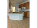 Well-lit kitchen featuring granite countertops and stainless steel appliances at 512 Novara Way, Davenport, FL 33837