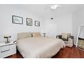 Bright bedroom featuring a comfortable bed, wood floors, and modern decor at 5566 Metrowest Blvd # 10, Orlando, FL 32811