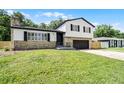 Charming two-story home featuring stone accents, black shutters, and a well-manicured lawn at 608 Pearl Rd, Winter Springs, FL 32708