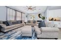Bright living room featuring a ceiling fan, comfortable seating, and sliding glass doors at 609 Big Pine Ave, Minneola, FL 34715