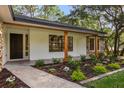 A close up of the exterior entrance showcasing stone accents and refreshed landscaping at 643 Princewood Dr, Deland, FL 32724