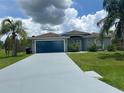 Charming single-story home featuring a well-maintained lawn, long driveway and a two-car garage at 739 Parrot Ct, Poinciana, FL 34759