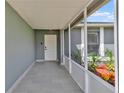 Inviting covered front porch with tiled floor and decorative landscaping, enhancing curb appeal at 845 Valnera Ct, Kissimmee, FL 34758