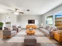 Bright living room boasts modern furniture, natural light and neutral walls, creating a welcoming atmosphere at 879 Tamerlane St, Deltona, FL 32725