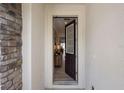 Inviting entryway with tiled floors, decorative stone wall, and a view into the home at 8951 Hilton Ridge Ave, Kissimmee, FL 34747