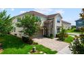 Charming two-story home with a stone facade, paved driveway, and well-maintained landscaping at 8951 Hilton Ridge Ave, Kissimmee, FL 34747