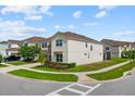 Corner lot home featuring a stone facade, a paved driveway, and manicured landscaping at 8951 Hilton Ridge Ave, Kissimmee, FL 34747