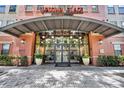 Welcoming building entrance with glass doors, lush greenery, and stylish design elements at 911 N Orange Ave # 443, Orlando, FL 32801