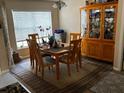 Inviting dining room showcases a wooden table with six chairs and a decorative china cabinet, perfect for Gathering gatherings at 10712 Fairhaven Way, Orlando, FL 32825