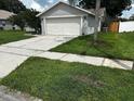 Charming single-Gathering home features a well-maintained lawn and a two-car garage, complete with a concrete driveway at 10712 Fairhaven Way, Orlando, FL 32825