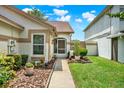Inviting home entrance with landscaped walkway and blooming flowers, creating a welcoming first impression at 11548 Pumpkin Seed Ct, Orlando, FL 32821