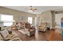 Cozy living room with hardwood floors, comfortable seating, and natural light creating a warm atmosphere at 11548 Pumpkin Seed Ct, Orlando, FL 32821