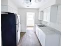 Bright kitchen with white cabinets, modern appliances, and gray countertops, perfect for cooking at 1200 Ne 45Th Pl, Ocala, FL 34479