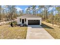 Charming new construction home featuring a concrete driveway and inviting front entrance at 1720 Sw Big Tree Rd, Dunnellon, FL 34431