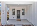 Inviting front porch view featuring two windows on either side of the front door at 1720 Sw Big Tree Rd, Dunnellon, FL 34431