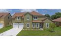 Well maintained home with lush green lawn, driveway, and mature shrubbery at 1929 Sipes Ave, Sanford, FL 32771