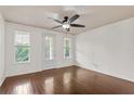 Bright bedroom with a ceiling fan and three windows with access to the outside at 2058 Prospect Ave, Orlando, FL 32814