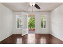 Bedroom with dark wood floors, fan and private balcony, offering a serene retreat at 2058 Prospect Ave, Orlando, FL 32814