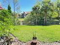 Well-manicured backyard with lush green grass and views of neighboring buildings at 249 Afton Sq # 112, Altamonte Springs, FL 32714
