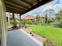 Scenic patio view overlooking a lush green lawn and beautifully landscaped gardens at 249 Afton Sq # 112, Altamonte Springs, FL 32714