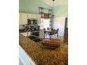 Bright kitchen with stainless steel appliances, a cozy dining area, and modern countertops at 2650 Autumn Creek Cir, Kissimmee, FL 34747