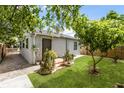 Backyard with lush grass, mature trees, brick-lined walkway, and an iron-grate security door at 320 Eaton St, Maitland, FL 32751