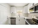 Bright, updated kitchen featuring white cabinets, stainless steel appliances, modern fixtures, and light countertops at 320 Eaton St, Maitland, FL 32751