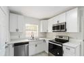 Bright, updated kitchen featuring white cabinets, stainless steel appliances, modern fixtures, and light countertops at 320 Eaton St, Maitland, FL 32751
