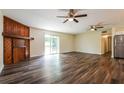 Living room features hardwood floors, a decorative wood fireplace, and a glass sliding door at 3312 Victory Palm Dr, Edgewater, FL 32141