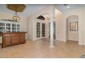 Open foyer featuring tile flooring, arched doorways, and elegant bar area at 336 Highcroft Ct, Lake Mary, FL 32746