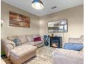 Cozy living room featuring plush furniture, a decorative fireplace, and warm neutral tones at 3640 Sail Harbor Dr, Kissimmee, FL 34746