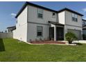 Stylish two-story home with well-kept lawn and landscaping, and a gray two-car garage at 3823 Spruce Creek Dr, Lakeland, FL 33811