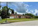 A single-story house with a well-kept lawn and neutral color scheme at 385 Lynchfield Ave, Altamonte Springs, FL 32714