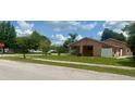 A single-story home with well-kept lawn and a covered car-port at 385 Lynchfield Ave, Altamonte Springs, FL 32714