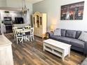 Inviting living space with dining area, comfortable seating, and view into the kitchen at 4011 Venetian Bay Village # 104, Kissimmee, FL 34741