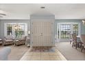 Bright foyer with tiled flooring, double doors, and bay windows offering a glimpse into the living spaces at 548 Timber Ridge Dr, Longwood, FL 32779