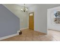 Inviting entryway featuring tile flooring, fresh paint, and a decorative chandelier at 5852 Mariposa Cove Ln, Orlando, FL 32822