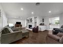 Bright living room with hardwood floors, fireplace, built-in shelves, and an open layout to the kitchen at 610 Kittredge Dr, Orlando, FL 32805