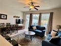 Inviting living room featuring a comfortable seating area and natural light from sliding glass doors at 7682 Sir Kaufmann Ct, Kissimmee, FL 34747