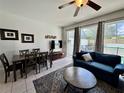 Inviting living room featuring a comfortable seating area and natural light from sliding glass doors at 7682 Sir Kaufmann Ct, Kissimmee, FL 34747