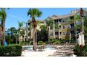 Resort-style condo community featuring a sparkling pool, palm trees, and plenty of lounge chairs at 7682 Sir Kaufmann Ct, Kissimmee, FL 34747