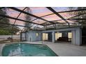 Back patio and pool with screened in enclosure, ideal for entertaining and relaxation at 857 Marquis Ct, Kissimmee, FL 34759