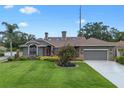 Beautiful exterior of a single-Gathering home with lush landscaping, a well-kept lawn, and a driveway at 9324 Carolview Way, Orlando, FL 32836