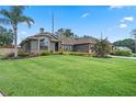 Beautifully landscaped front yard with lush green grass and mature trees, creating a welcoming curb appeal at 9324 Carolview Way, Orlando, FL 32836