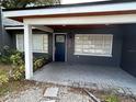 Close up of entryway, dark painted brick with white trim and a blue door at 1130 W Lake Brantley Rd, Altamonte Springs, FL 32714