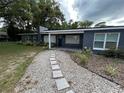 Inviting single-story home with a quaint walkway and lush landscaping enhancing curb appeal at 1130 W Lake Brantley Rd, Altamonte Springs, FL 32714